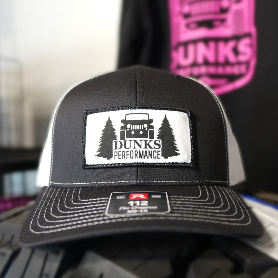 Black cap with Dunks Performance logo on a blurred background