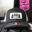 Black cap with Dunks Performance logo on a blurred background