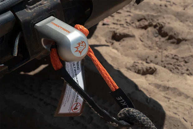 Rope anchor system attached to a vehicle on a sandy surface