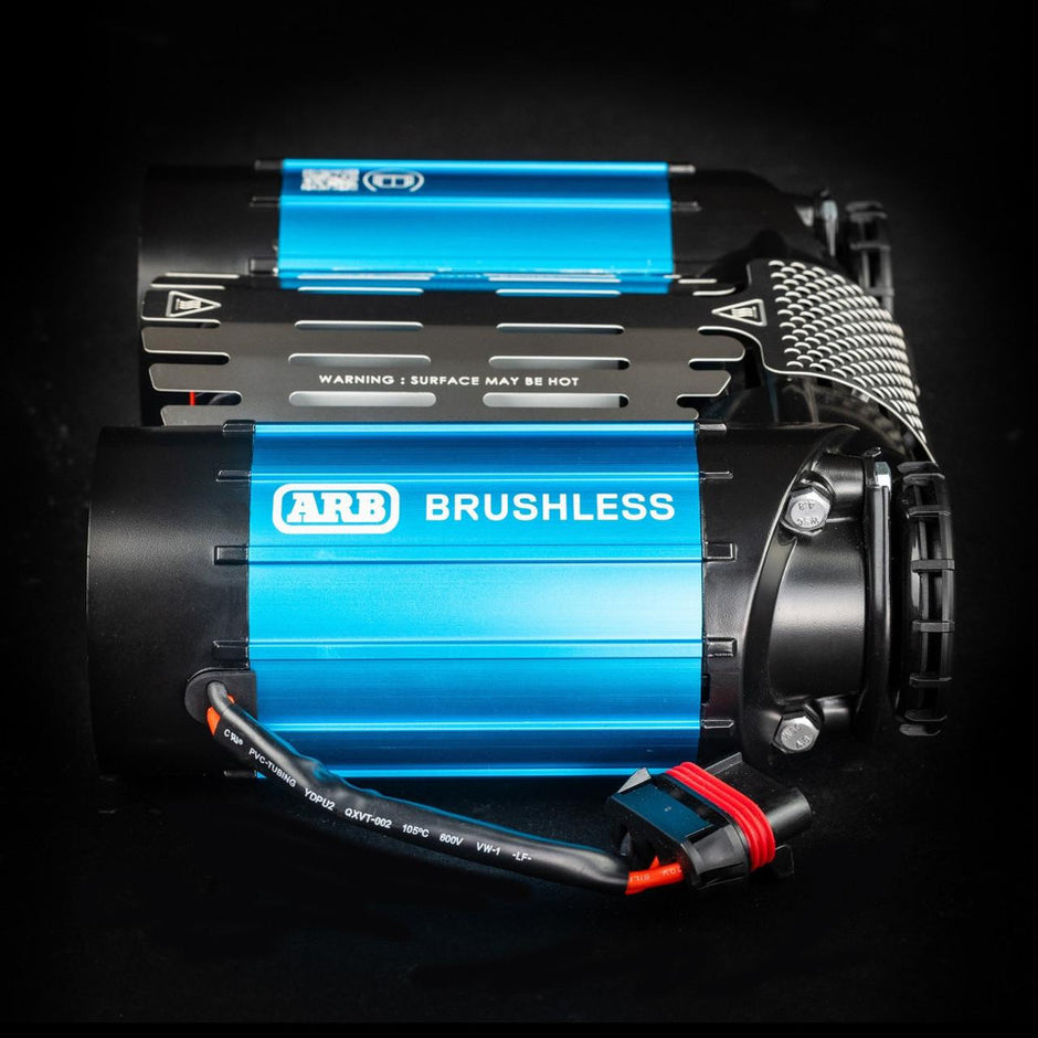 Side view of the ARB CKBLTA12 brushless twin air compressor highlighting the blue cooling fins.
